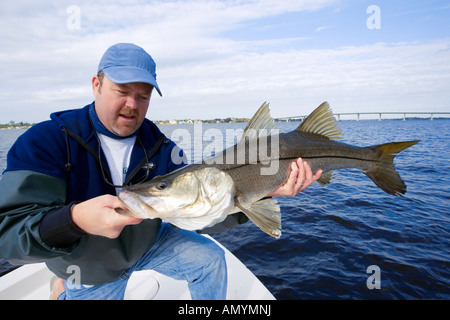 Man holding freshly caught snook fish in Stuart, Florida, USA Stock Photo