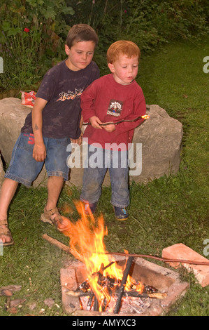 Mr Children Having A Barbecue At An Open Fire Place Campfire Game With Fire Stock Photo Alamy