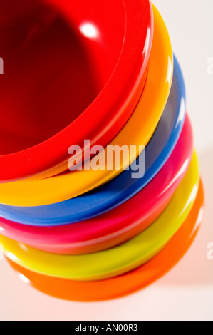 Set of six small multi-coloured bowls, piled up and shot from above on a white background Stock Photo