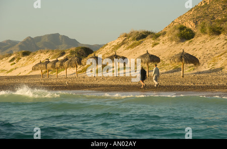 Mexico Baja California Village of Cabo Pulmo Couple walking along the shoreline of the Sea of Cortez Stock Photo