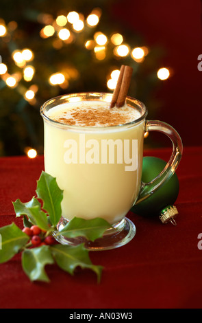 Eggnog with Holly and Christmas Tree in Background Stock Photo