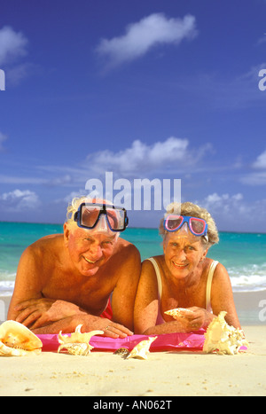 USA, Hawaiian Islands. Elderly couple posing with sea shells wearing diving gear Stock Photo
