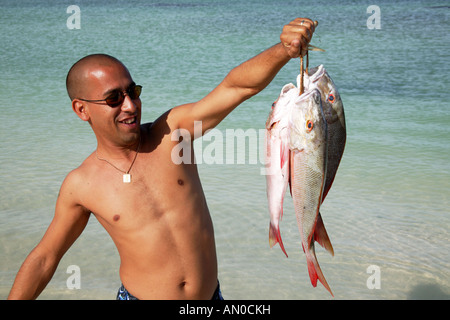 Man holding up three Pargo fish at Cayo Jutia, Pinar Provine, Cuba. Stock Photo