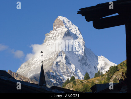 Peak of Matterhorn mountain with spire & weather clock of the English Church in Zermatt silhouetted in front Valais Switzerland Stock Photo