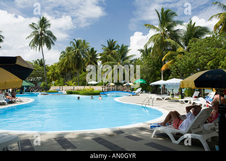 Maldives Addu Atoll Gan Equator Village Resort guests relaxing by the swimming pool Stock Photo