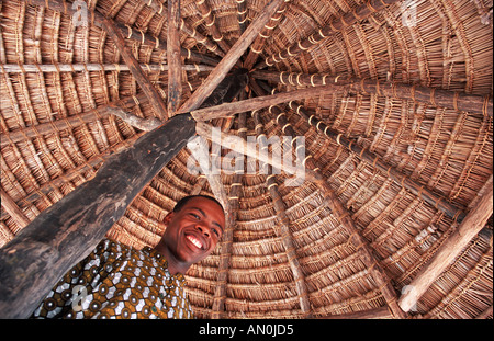 Friendly Mafia islander Pole Pole Lodge eco resort Under a thatch parasol Mafia Indian Ocean Tanzania East Africa Stock Photo