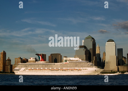 Cruise ship passes the Manhattan skyline along the Husdon River as it departs from New York City USA July 2005 Stock Photo