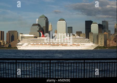 Cruise ship passes the Manhattan skyline along the Husdon River as it departs from New York City USA July 2005 Stock Photo