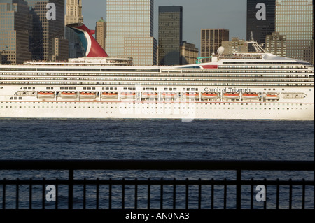 Cruise ship passes the Manhattan skyline along the Hudson River as it departs from New York City USA July 2005 Stock Photo