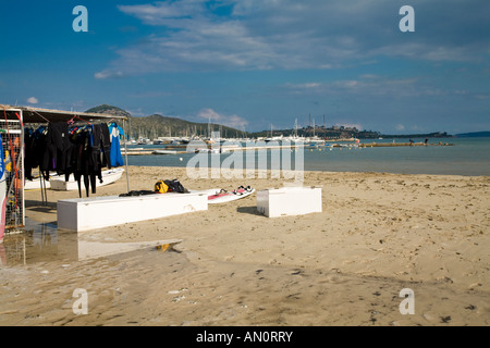 Stacked surf boards and catamarans on the beach at Port de Pollenca Majorca Balearic Islands Spain Stock Photo