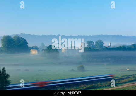 train passing Old Sherborne Castle in the mist at dawn Sherborne Dorset England UK
