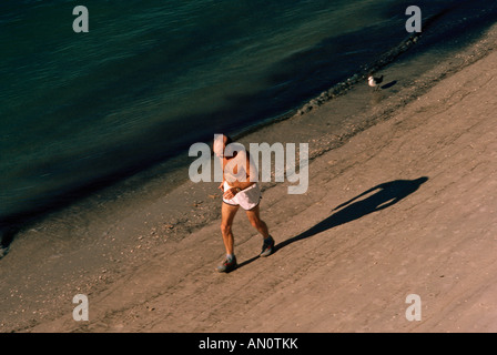 Senior jogging on beach in Florida USA Stock Photo