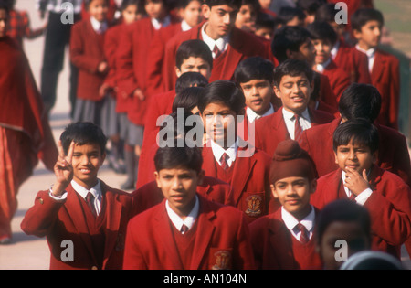 Group of school boys and girls wearing crimson uniform taking part in school trip. India Stock Photo