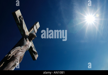 Statue of Jesus Christ on Cross with sunshine Stock Photo