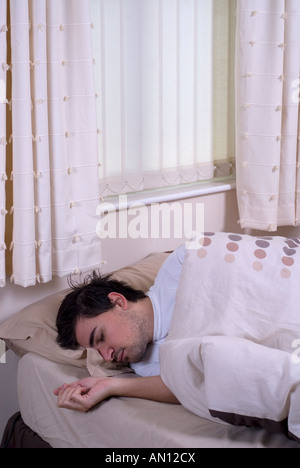 Man sleeping in bed Stock Photo