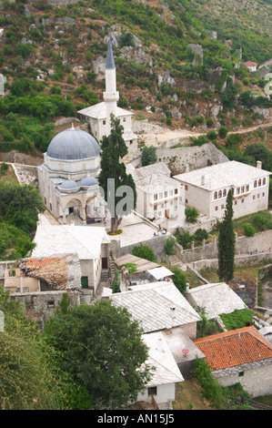 View from the hilltop tower over the town with mosque and church, rooftops. Pocitelj historic Muslim and Christian village near Stock Photo