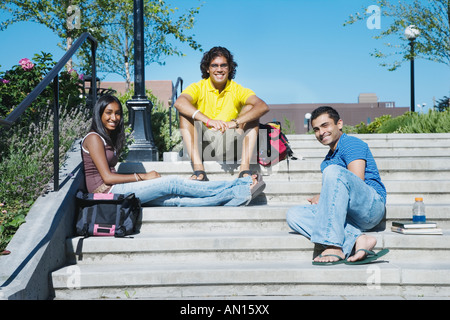 Multi-ethnic college students sitting on steps Stock Photo