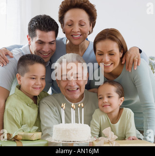 Senior Hispanic man celebrating birthday with family Stock Photo