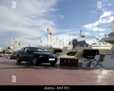 Sports cars parked next to yachts in the Luxury marina of Puerto banus,  Marbella, Spain Stock Photo - Alamy