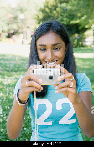 Indian woman taking photograph Stock Photo