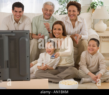 Multi-generational Hispanic family watching television Stock Photo