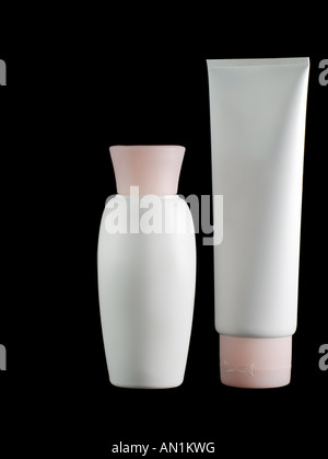 White tubes of a cream with pink covers on a black background Stock Photo