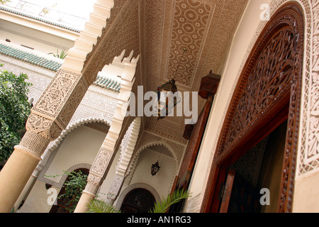 Morocco Marrakesh Villa des Orangers carved wooden door and murquana plasterwork Stock Photo