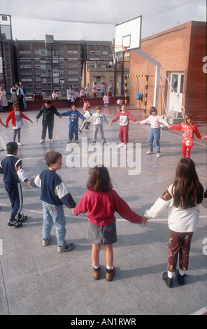 Primary school playground in Barcelona with young children doing Sardana dance. Stock Photo