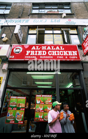England,London,Brick Lane,Asian Youths Eating Fast Food Stock Photo
