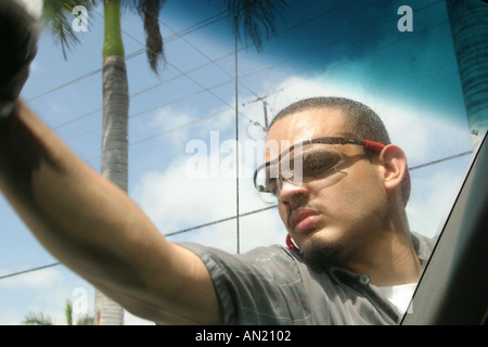 Miami Florida,Biscayne Boulevard,Jiffy Lube,vehicle oil change business,employee wipes windshield clean,visitors travel traveling tour tourist tourism Stock Photo