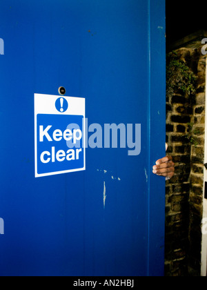 person closing security door Stock Photo