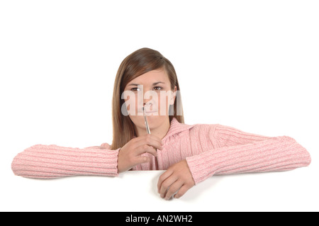 a cutout of a teenage girl writing a letter thinking hard what to say Stock Photo