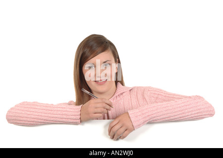 a cutout of a teenage girl writing a letter thinking hard what to say Stock Photo