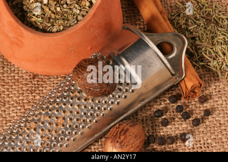 Spices and Herbs with a grater on a Hessian base Stock Photo