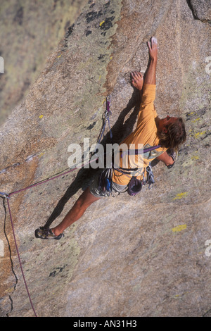 Rock climber reaching for a handhold Stock Photo - Alamy