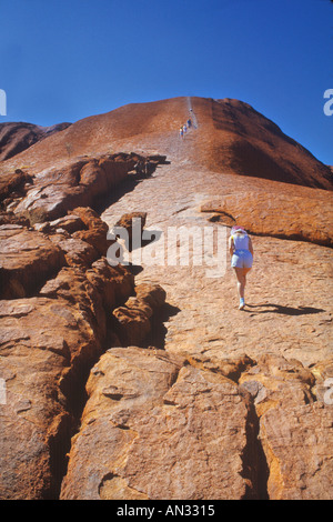 Tourist Climbing Ayers Rock, Australia Stock Photo