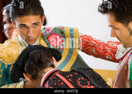 Bullfighter being helped by his assistants to get dressed for the paseillo or initial parade. Stock Photo