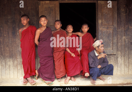 Novice monks outside the rural monastery in Shwe Min Bone village Shan State near Kalaw Burma Stock Photo