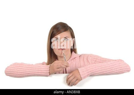 a cutout of a teenage girl writing a letter thinking hard what to say Stock Photo