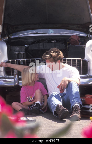 Father and daughter fixing car engine in driveway Stock Photo: 71140063 ...