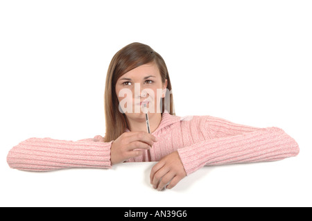 a cutout of a teenage girl writing a letter thinking hard what to say Stock Photo