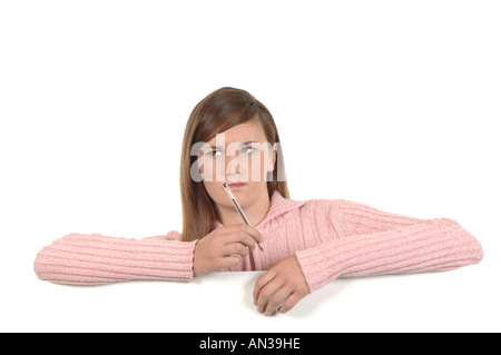 a cutout of a teenage girl writing a letter thinking hard what to say Stock Photo