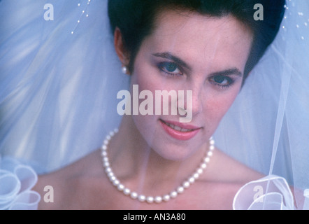 Portrait of caucasian bride smiling through veil Stock Photo