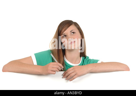 a cutout of a teenage girl writing a letter thinking hard what to say Stock Photo