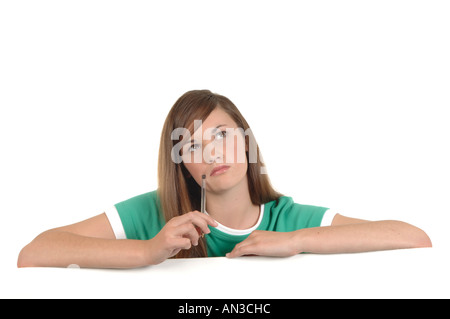 a cutout of a teenage girl writing a letter thinking hard what to say Stock Photo