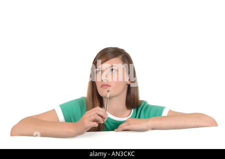 a cutout of a teenage girl writing a letter thinking hard what to say Stock Photo