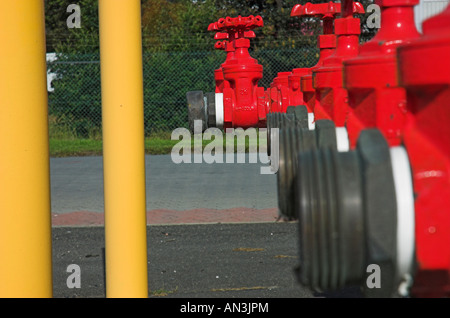 Red fire hydrants at industrial site Stock Photo