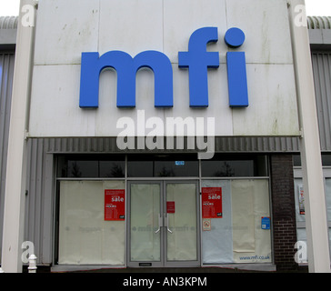 A closed MFI store with the windows boarded up in Merthyr Tydfil Stock Photo