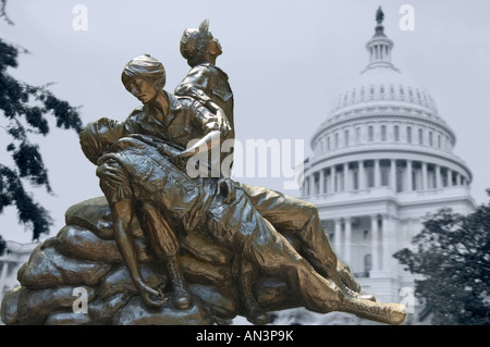 Memorial statues to Vietnam war Women Nurse Arlington USA with Capitol ghost picture behind Stock Photo