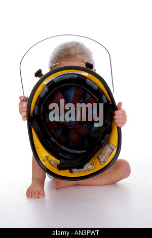 '18 month old Charlie plays with a firemans hat' Stock Photo